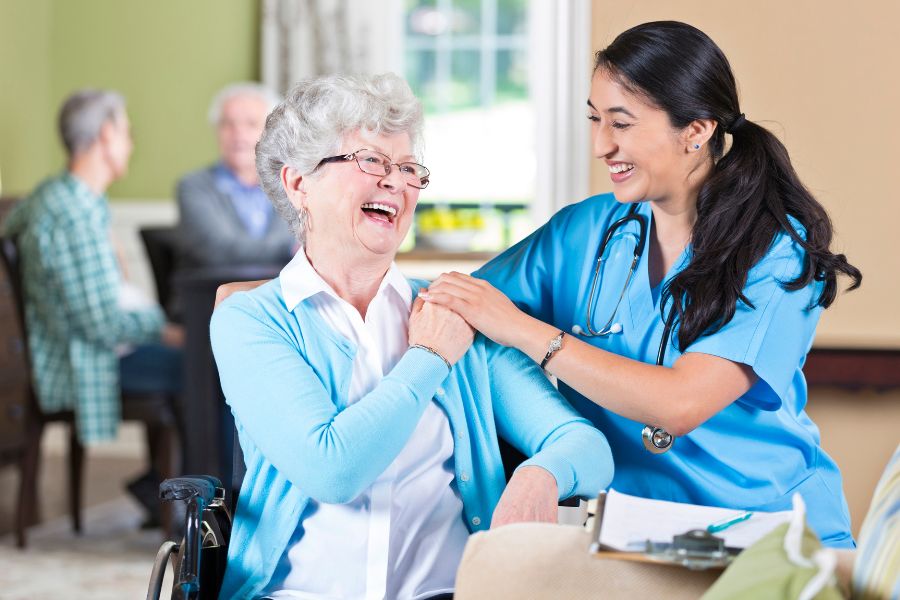 image presents nurse and elder woman laughing