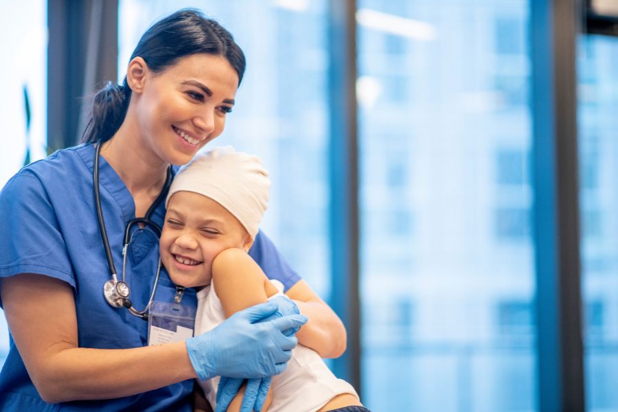 image presents nurse hugging child patient