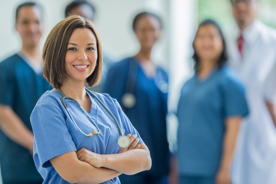 image presents nurse smiling in front and some nurses at the back